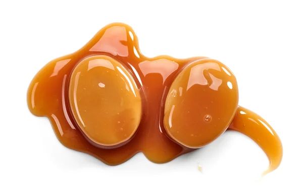 Caramel candies and sweet sauce — Stock Photo, Image