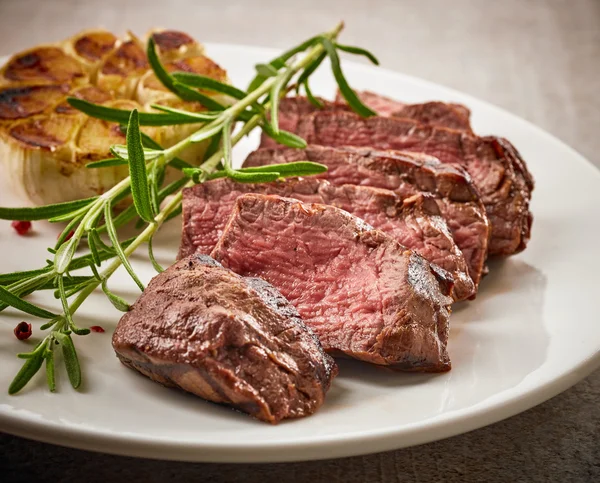 Grilled steak on white plate — Stock Photo, Image