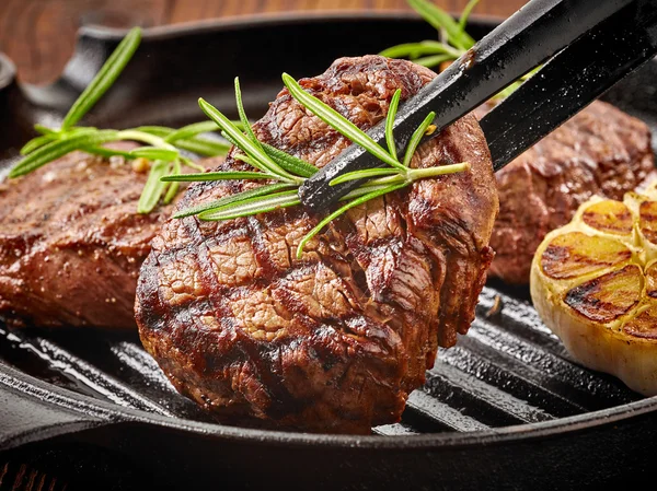 Beef steak on cooking pan — Stock Photo, Image