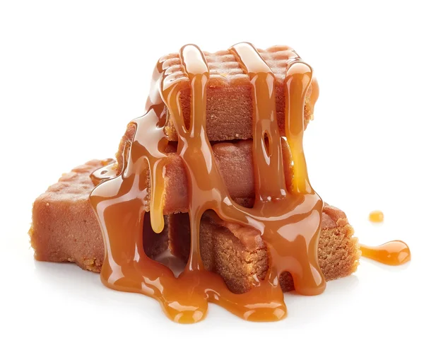 Caramel candies and sauce — Stock Photo, Image