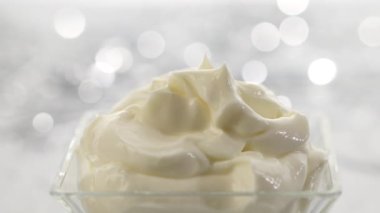 Böğürtlenler gümüş bir bokeh şenlik arka planında çırpılmış mascarpone kremine düşer.