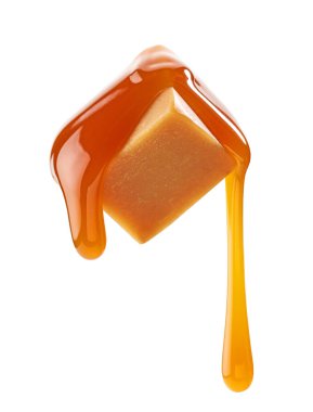 caramel sauce flowing on flying caramel candy isolated on white background clipart