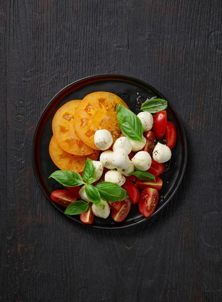 Plate Tomato Mozzarella Salad Black Wooden Kitchen Table Top View — Stock Photo, Image