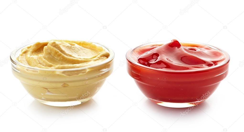 bowls of mustard sauce and ketchup