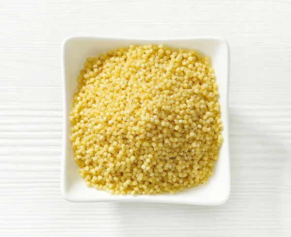 Bowl of millet grains — Stock Photo, Image