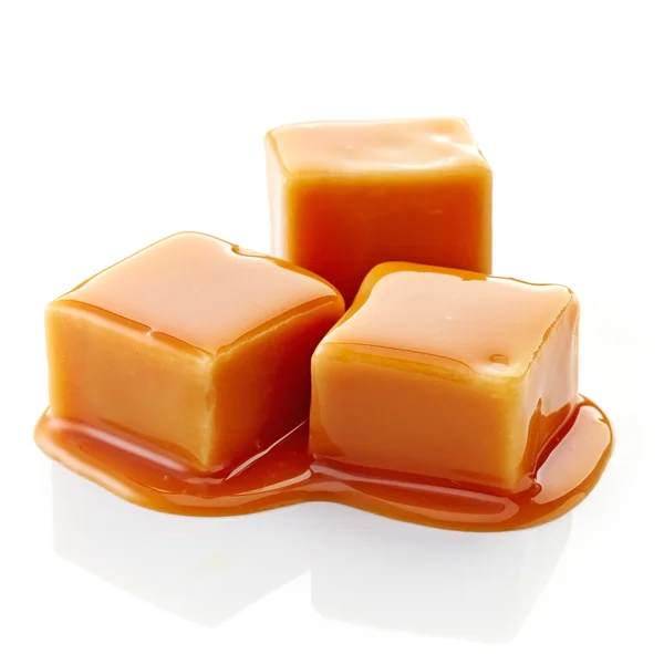 Caramel candies and caramel sauce — Stock Photo, Image