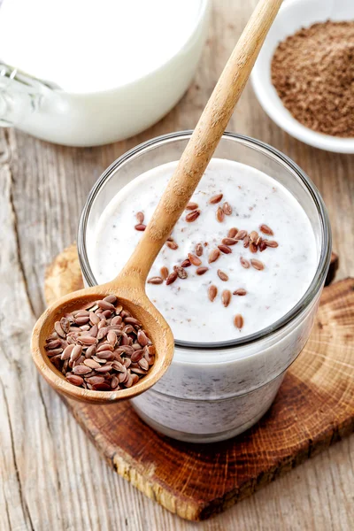 Glass of greek yogurt with crushed flax seeds — Stock Photo, Image