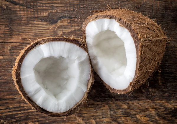 Coconut on old wooden table — Stock Photo, Image