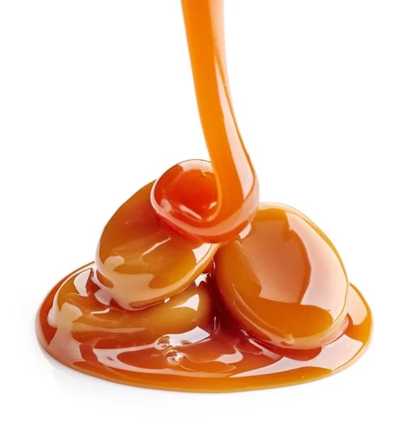 Caramel candies and sauce — Stock Photo, Image