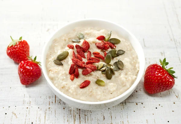 Oat porridge with healthy seeds — Stock Photo, Image