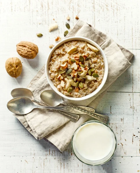 Bowl of breakfast porridge with nuts — Stock Photo, Image