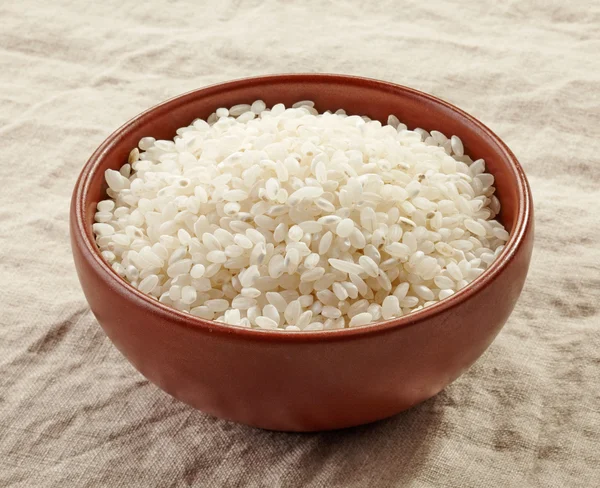 Bowl of raw round rice — Stock Photo, Image