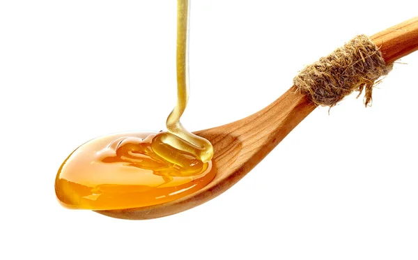 Wooden spoon of honey — Stock Photo, Image