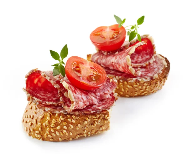 Toasted bread with salami and tomato — Stock Photo, Image