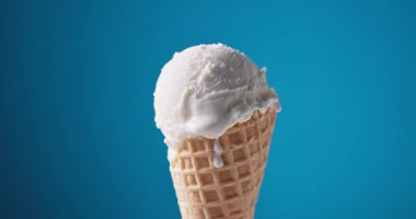 Waffle külahında vanilyalı dondurma, mavi arkaplanı açıyor.