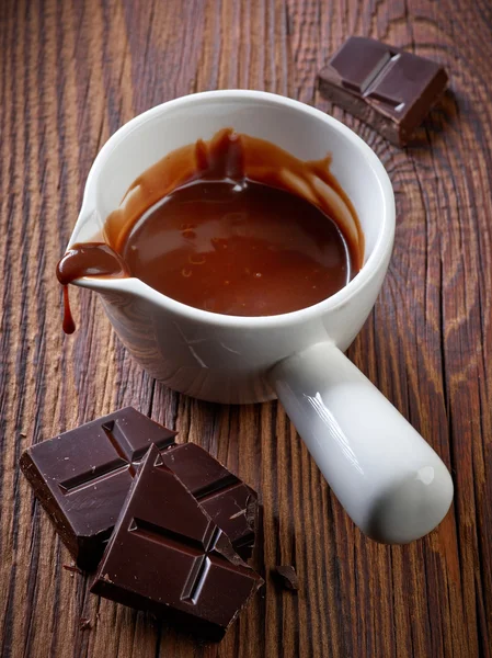 Chocolate sauce and pieces — Stock Photo, Image