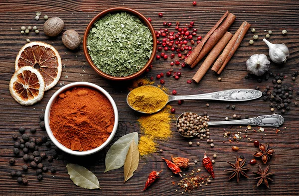 Various spices on old wooden table — Stock Photo, Image