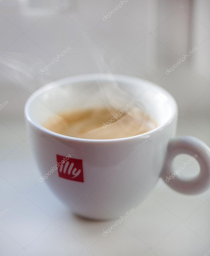 Riga, Latvia - November 22, 2015: Cup of illy espresso coffee on white table. Illycaffe is a worldwide coffee roasting company, its espresso is very popular in Latvia and EU.