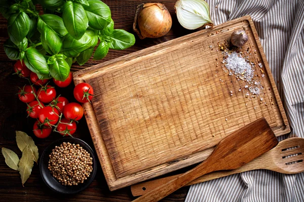 Cooking background with old cutting board — Stock Photo, Image