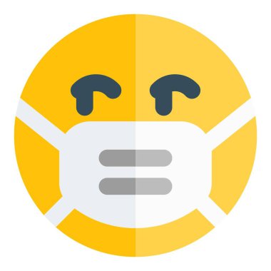 Maske takarken sağ tarafa bakan emojiyi uyar