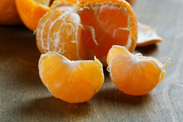 Peeled tangerines with slices on a table — Stock Photo, Image
