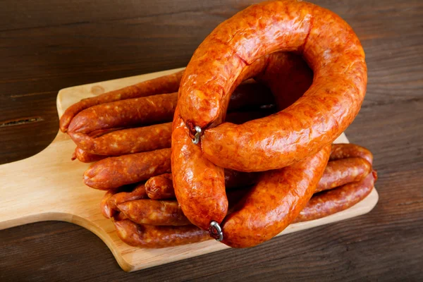 Smoked sausage on a kitchen table — Stock Photo, Image