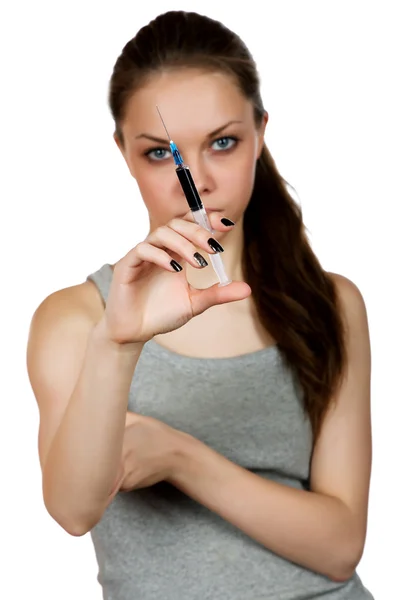 Girl about a syringe in  hand on  white background — Stock Photo, Image