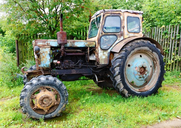 Antiguo tractor en calle rural — Foto de Stock