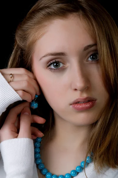 Portrait of the girl with earrings and a beads — Stock Photo, Image