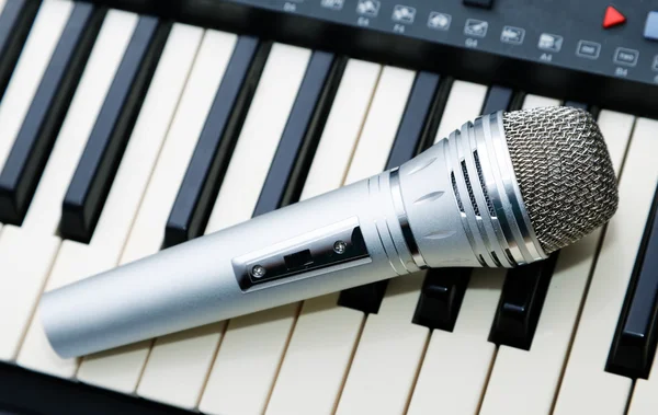 The microphone lies on the synthesizer keyboard — Stock Photo, Image