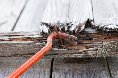 claw hammer and rusty nails on the old boards clipart