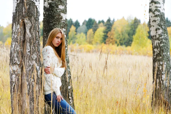 Woman among birches in the autumn field — Stock Photo, Image
