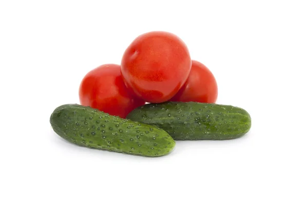 Red  tomatoes and green cucumbers Stock Image