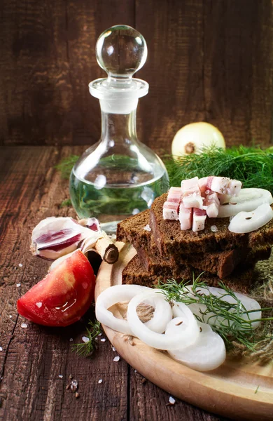 Feast still life. Bread with bacon, onion and other greens — Stock Photo, Image