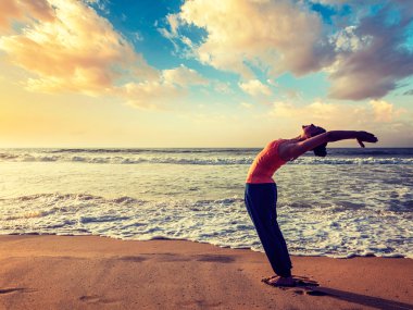 Sportif genç kadının yoga Sun salutation Surya Namaskar yapması yerleştirmek