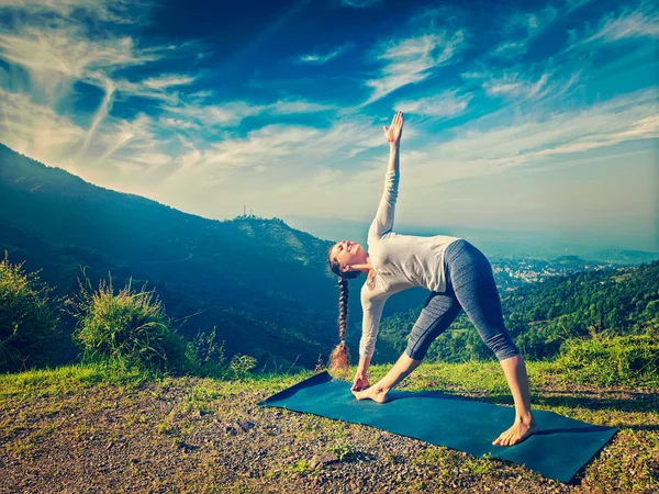 Mulher fazendo Ashtanga Vinyasa ioga asana Utthita trikonasana — Fotografia de Stock