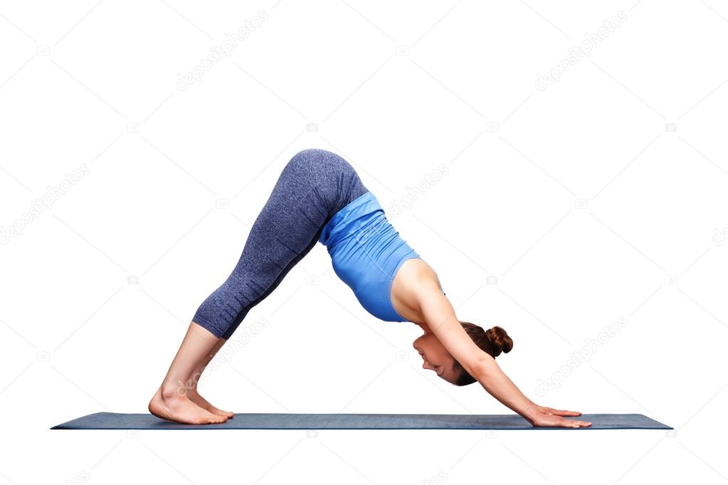 Beautiful sporty fit yogi girl practices yoga asana adhomukha sv