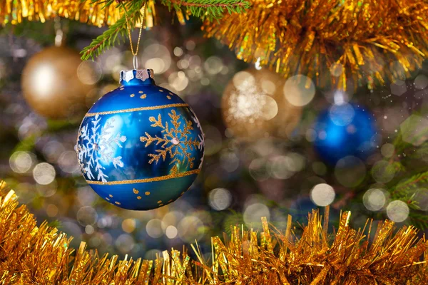 Decoration bauble on decorated Christmas tree Royalty Free Stock Photos