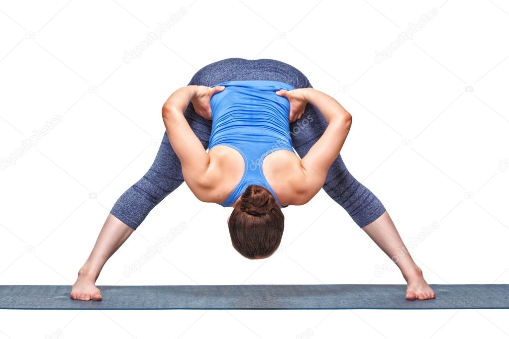 Sporty fit woman doing yoga asana Prasarita padottanasana B