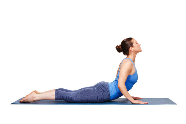 Sporty fit yogini woman practices yoga asana bhujangasana