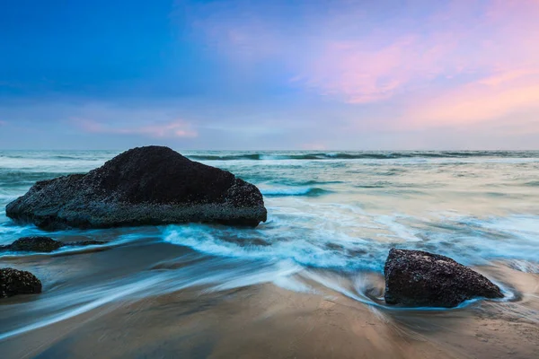 Waves and rocks on beach of sunset — Stock Photo, Image