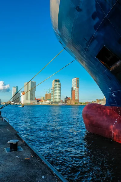 View of Rotterdam skyscrapers skyline from under cargo vessel moored to the quay of Nieuwe Maas river — Stock Photo, Image