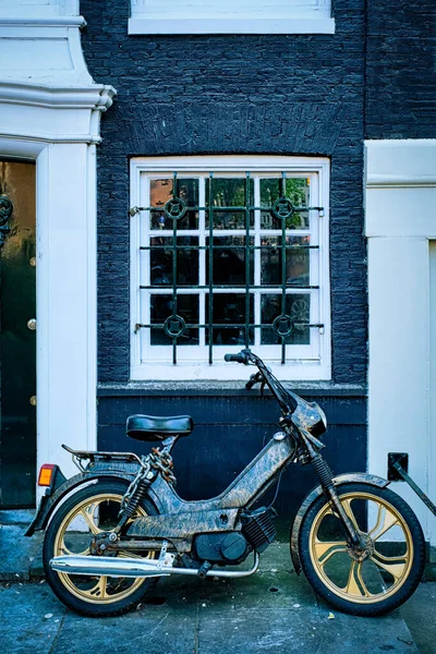Motorbike parked near old house in Amsterdam street,