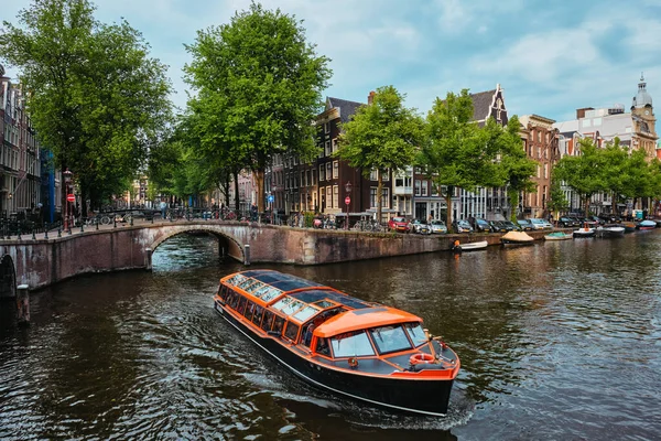 Blick auf Amsterdam - Kanal mit Bootssteg, Brücke und alten Häusern — Stockfoto