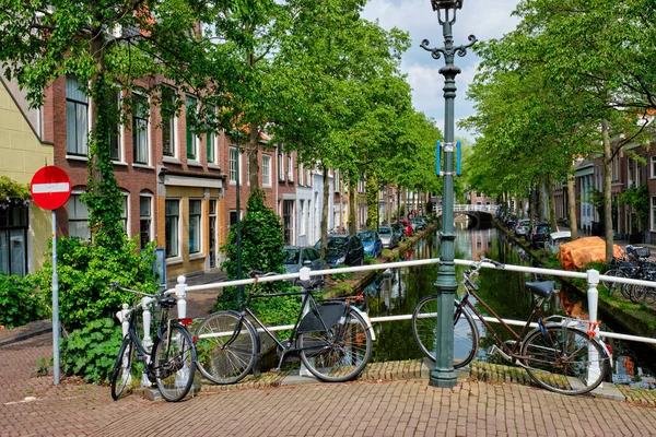 Fahrrad auf Brücke und Kanal mit in der Delfter Straße geparkten Autos — Stockfoto