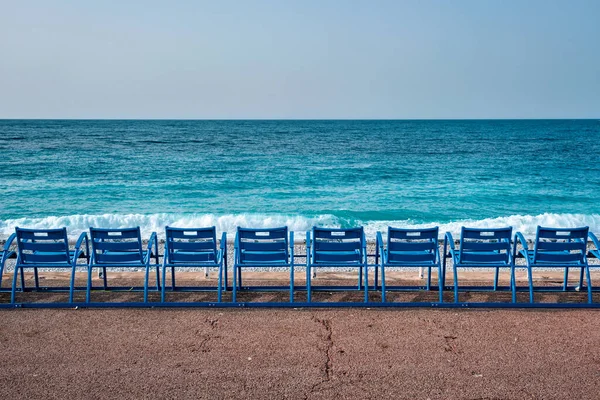 Famous blue chairs on beach of Nice, France