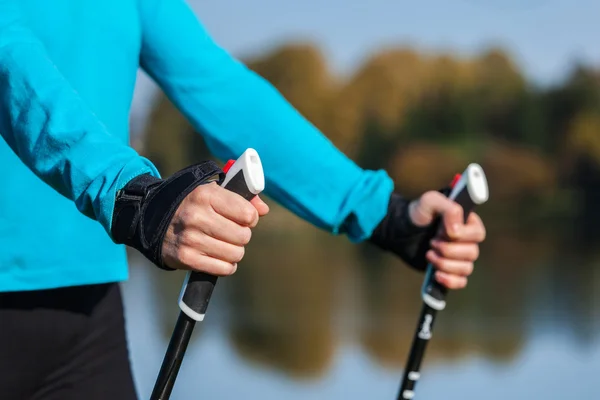 Primo piano delle donne mano con bastoni da nordic walking — Foto Stock