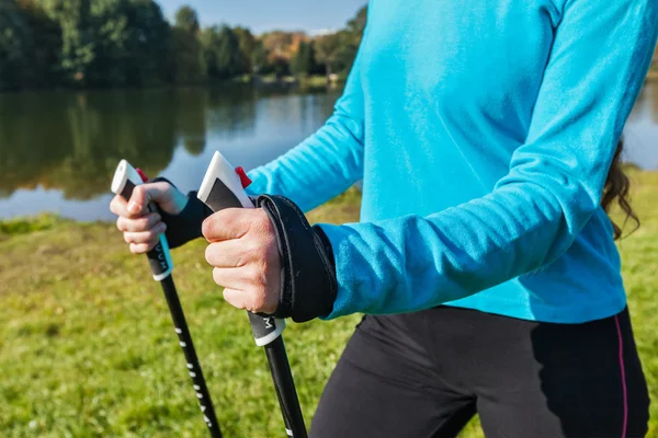 Closeup of womans hand with nordic walking poles — Stock Photo, Image