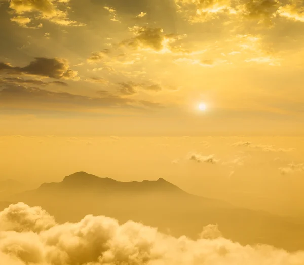 Mountains in cloud on sunset — Stock Photo, Image
