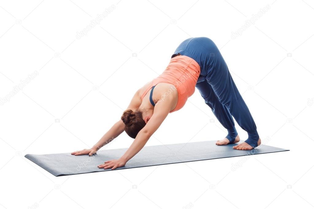 Beautiful sporty fit yogi girl practices yoga asana adhomukha sv